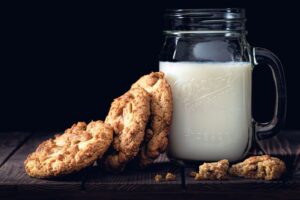Benefits of Full Fat Dairy [Image description: photo of glass of milk and cookies] representing a snack of full fat milk and cookies of a client in eating disorder recovery in California