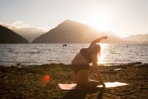 Fat Positive Photography in Eating Disorder Recovery in Los Angeles, California [Image description: photo of a larger bodied woman in a swim suit doing a yoga pose on the beach] Represents diverse images for people in eating disorder recovery