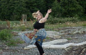 exercise as joyful movement in eating disorder recovery in California [Image description: a larger bodied woman dances outside] Represents a potential woman in treatment for an eating disorder in Los Angeles, California 