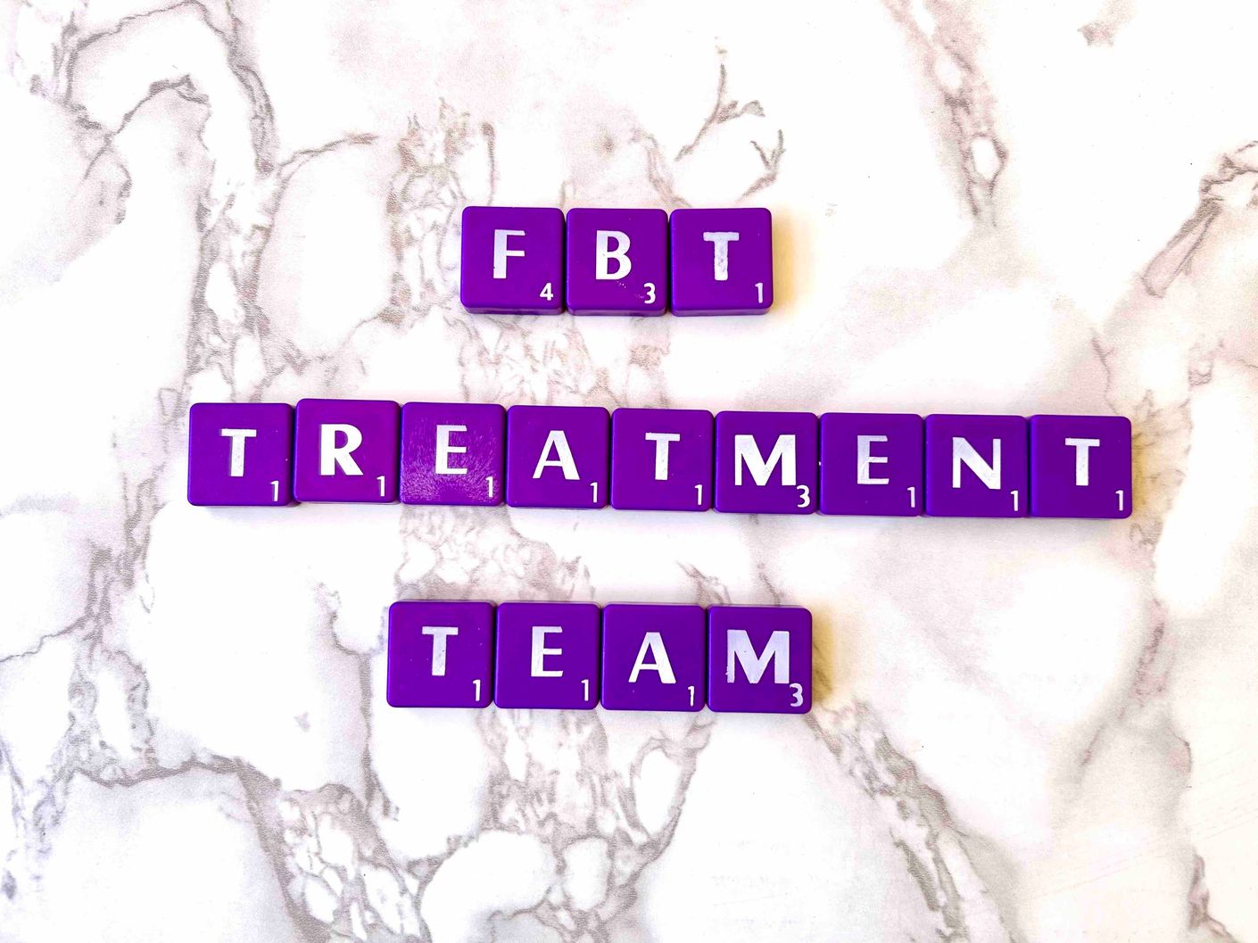 FBT Treatment Team Including Therapist, Dietitian, and Medical Doctor in Los Angeles, California [Image description: Purple scrabble tiles spelling "FBT Treatment Team"]