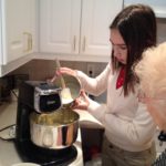 Making poundcake with Nana [Image description: photo of a teen girl operating a mixer and an old woman watching] represents eating disorder recovery in Los Angeles, California 