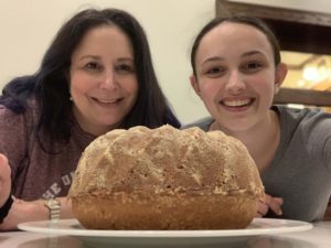Cultural connection through food and eating disorder recovery in Los Angeles, California [Image description: photo of the author, Lauren Muhlheim, and her daughter with a freshly baked poundcake]