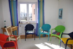 FBT treatment teams [Image description: different colored chairs in a group room]
