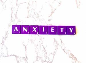 Anxiety counseling in Los Angeles, California [Image description: purple scrabble tiles spelling "Anxiety"]