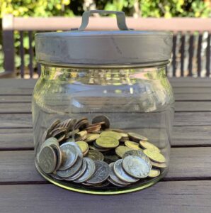 Easing Grief Through Connection (Coping Strategy for the Holidays) [Image description: jar of dimes] representing a person receiving support for grief in Los Angeles, California 