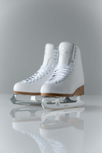 Weight bias and figure skating in Los Angeles, California [Image description: photo of a pair of white ice skates] Represents the skates of a fat skater