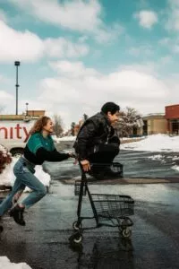 Parenting During FBT [Image description: photo of one teen pushing another in a shopping cart] Represents a potential family with teens getting help for an eating disorder in Los Angeles, California 