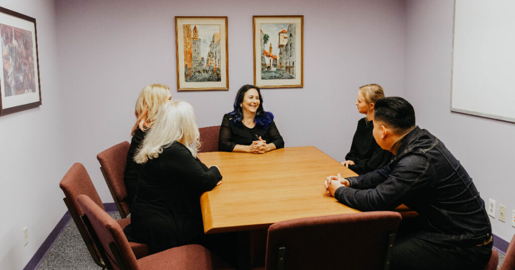 Eating disorder specialists at Eating Disorder Therapy LA in Los Angeles, California [Image description: staff members seated around a conference table]