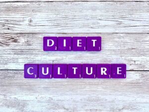 Diet Culture [Image description: Purple scrabble tiles spelling "diet culture"] in Los Angeles, California