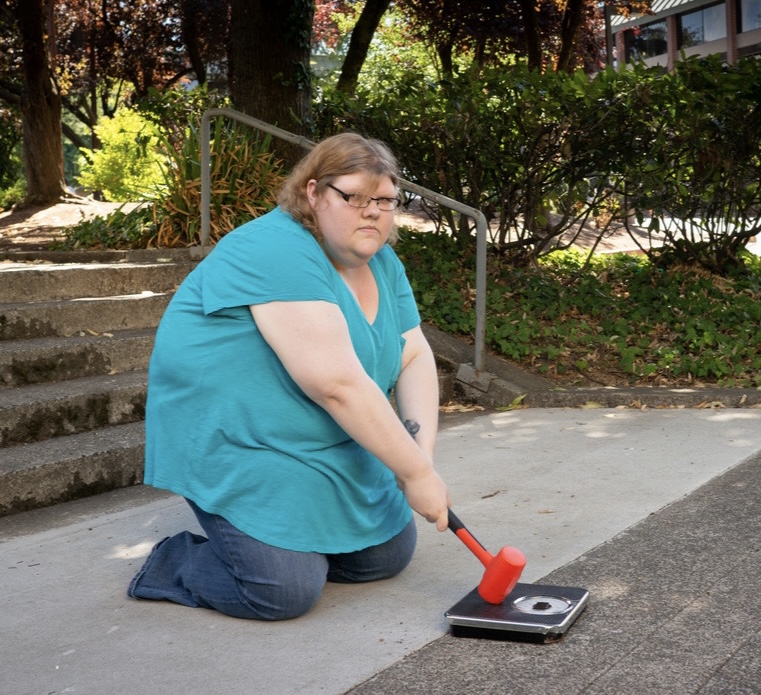 What Parents Need to Know About Diet Culture [Image description: a larger woman smashing a scale] Represents a potential parent of a teen receiving eating disorder counseling in Los Angeles, California