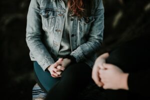 Individual therapy in FBT [Image description: photo of a teen seated and facing an adult] Represents a potential teen client in therapy for an eating disorder in Los Angeles, California 