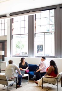 ARFID Parent Support Group open to parents in any location [Image description: 4 people in a circle having a conversation] represents potential parents of people with ARFID attending a parent support group