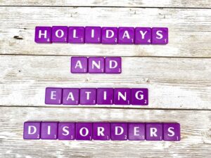Holidays and Eating Disorders in Los Angeles, California [Image description: purple scrabble tiles spelling "Holidays and Eating Disorders"]