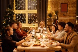 Holiday Eating Disorder in Los Angeles, California [Image description: photo of a family around a festive holiday table eating a meal together] Represents a potential family in Los Angeles, California 