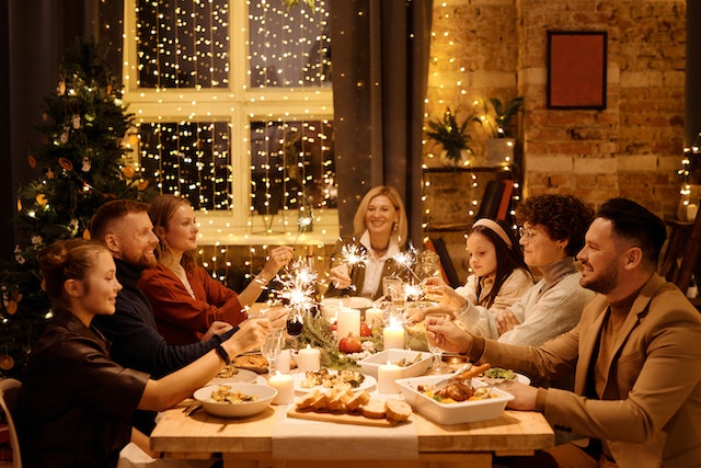 Holiday Eating Disorder in Los Angeles, California [Image description: photo of a family around a festive holiday table eating a meal together] Represents a potential family in Los Angeles, California