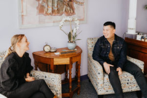 Therapy for college students with eating disorders in California [Image description: a female and male seated in a therapy office representing a potential college student seeking therapy for an eating disorder in Los Angeles, CA]