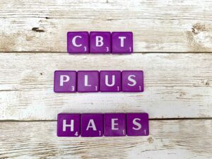 CBT Plus HAES [Image description: Purple scrabble tiles spelling "CBT plus HAES"] representing the eating disorder counseling provided at EDTLA in Los Angeles, California