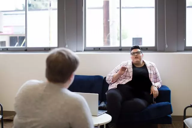 CBT plus HAES for Eating Disorders [Image description: large bodied gender neutral person seated and facing a therapist whose back is to the camera] represents a potential client with an eating disorder receiving CBT plus HAES in Los Angeles, California