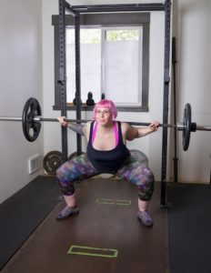 Atypical Anorexia [Image description: woman with pink hair lifting weights]