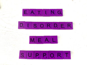 Eating Disorder Meal Support in Los Angeles, CA [Image description: purple scrabble tiles that spell "Eating Disorder Meal Support"]