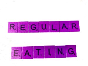 Regular Eating for Eating Disorder Recovery in Los Angeles, California [Image description: purple scrabble tiles spelling "Regular Eating"]