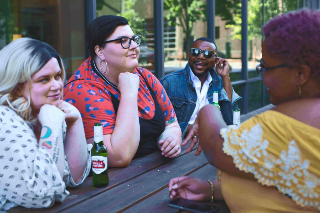 Helping Others in Your Life Understand Your ARFID [Image description: 4 friends of diverse sizes and skin colors sitting at a picnic table] Represents supportive friends of a potential client seeking help for ARFID in Los Angeles, CA