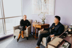 Eating disorder therapist jobs in Los Angeles, California [Image description: photo of a female and male sitting in therapy chairs in an office] Depicts potential therapists for group practice that is hiring