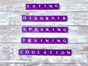 Eating Disorder Speaking, Training, and Education [Image description: purple scrabble tiles spelling "Eating Disorder Speaking, Training, and Education"]