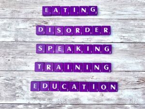 Eating Disorder Speaking, Training, and Education [Image description: purple scrabble tiles spelling "Eating Disorder Speaking, Training, and Education"]