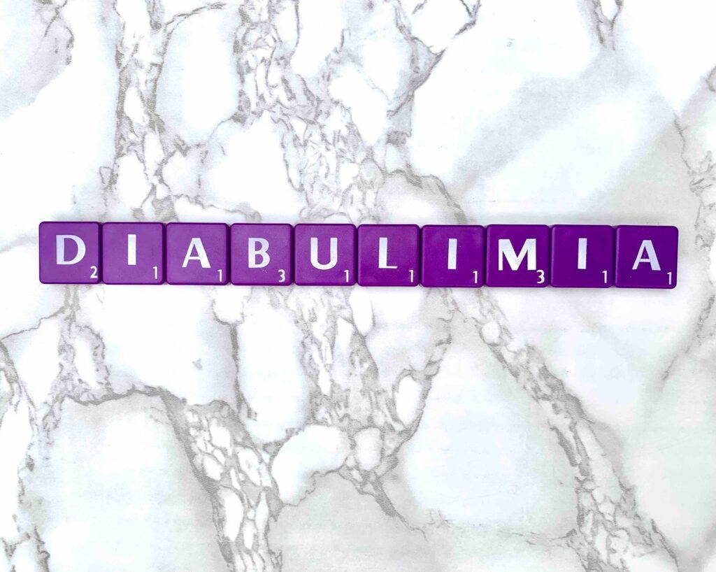 Diabulimia in Los Angeles, California [Image description: photo of purple scrabble tiles spelling "diabulimia"]