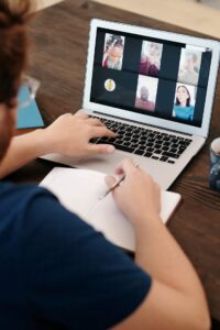 Online zoom group therapy in California [Image description: a man in a blue shirt having a virtual meeting] Represents a potential person with an eating disorder in California