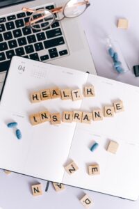 Using health insurance for eating disorders [Image description: scrabble tiles spelling "health insurance" on an open planner"]