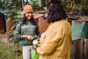 Teens and vegetarianism [Image description: Parent and child talking while holding gardening tools] represents a parent in California talking to a teen about their eating