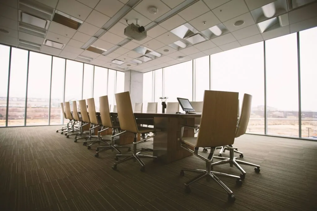 Private equity and eating disorders [Image description: an empty boardroom with windows] depicts a potential private equity firm investing in eating disorder centers