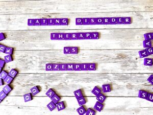 Eating disorder therapy versus Ozempic [purple scrabble tiles spelling "eating disorder therapy vs. Ozempic"]