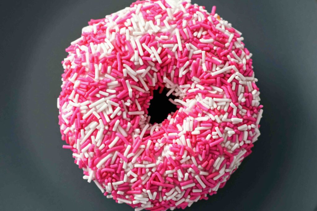 Donut with pink sprinkles--depicts a common fear food for people with eating disorders.