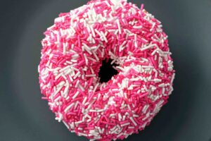 Donut with pink sprinkles--depicts a common fear food for people with eating disorders.