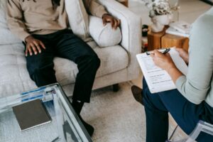 Therapy for Emetophobia in California [image description: 2 people seated in chairs representing a patient receiving therapy for emetophobia in California]