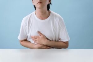Treatment for Vomiting Phobia [Image description: photo of person holding their stomach; depicts a potential patient with vomiting phobia in California]