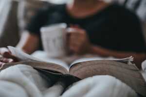 Person relaxing with a book and tea representing a potential patient in California | 92336 | 90650 | 94565 Person relaxing after pursuing body image therapy in Los Angeles